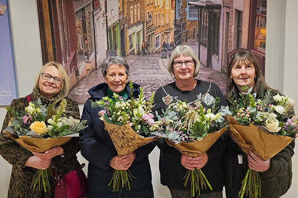 the staff with bouquets of flowers